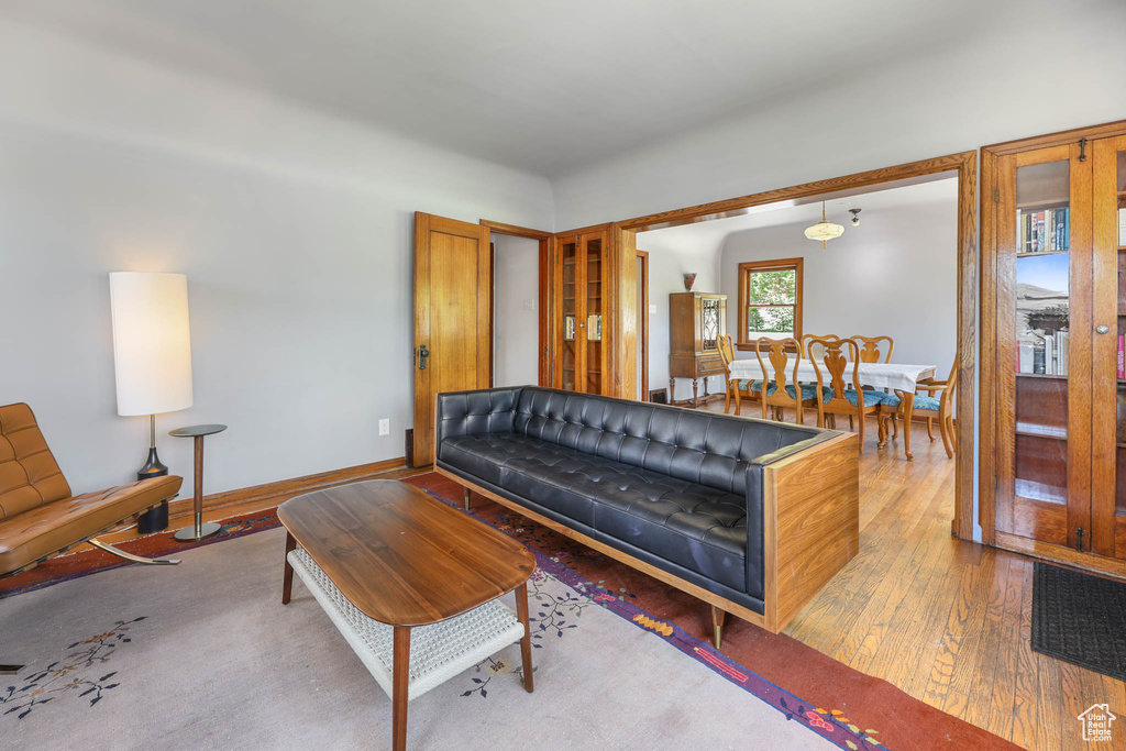 Living room with hardwood / wood-style floors and baseboards