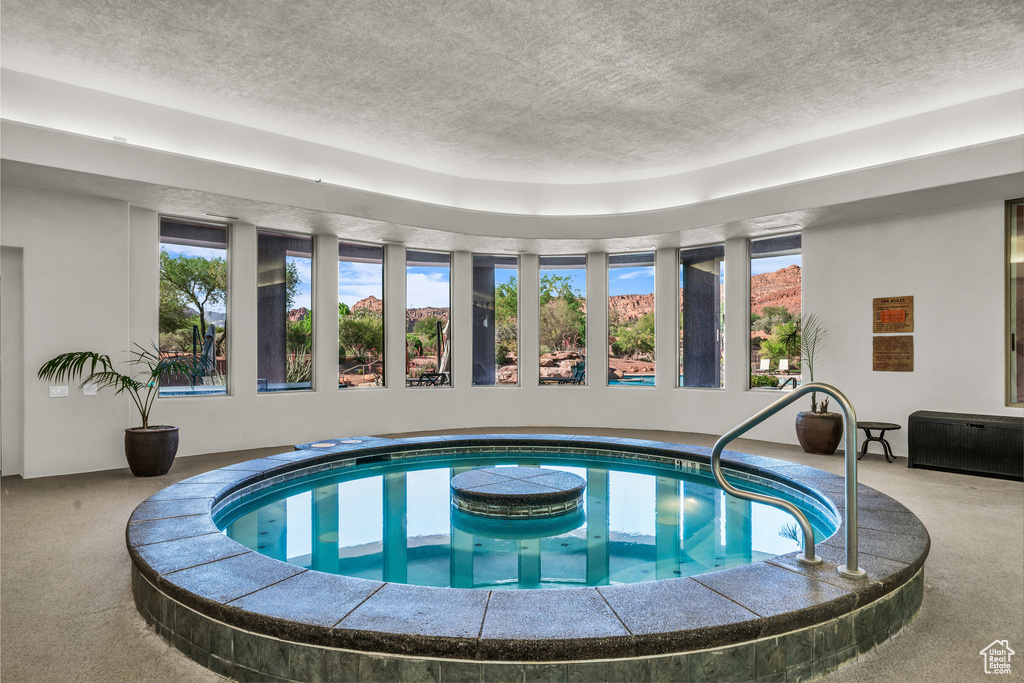 View of swimming pool with a pool and an indoor hot tub