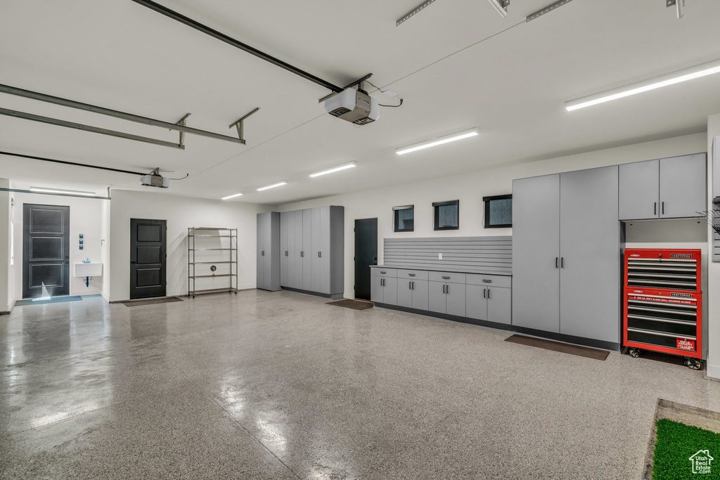 Garage with a garage door opener and a sink