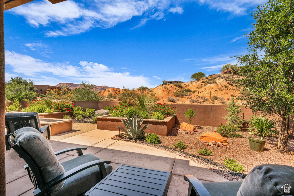 Fenced backyard with a patio area and a mountain view