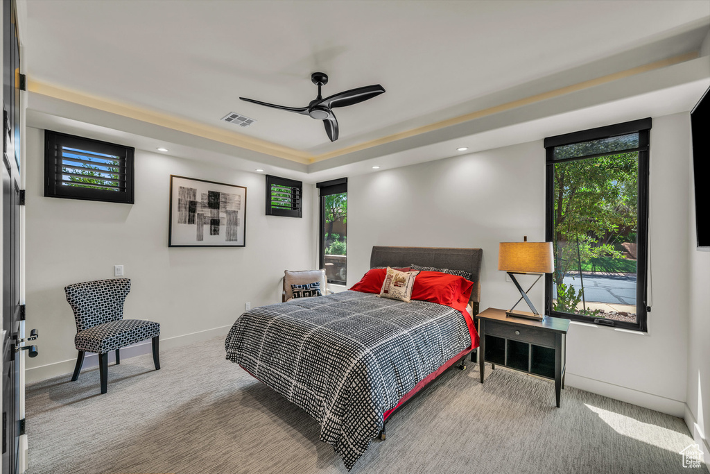 Bedroom featuring carpet floors, a tray ceiling, baseboards, and recessed lighting