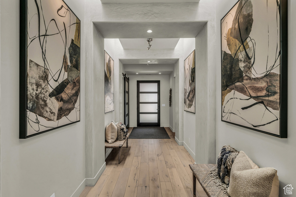 Hall with baseboards and light wood-type flooring