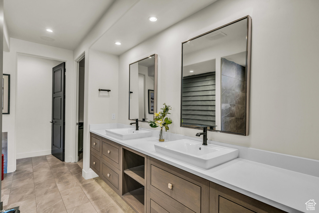 Full bath with double vanity and recessed lighting