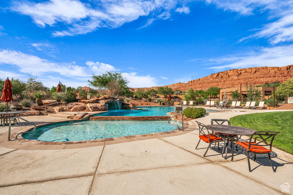 Community pool with a mountain view and a patio