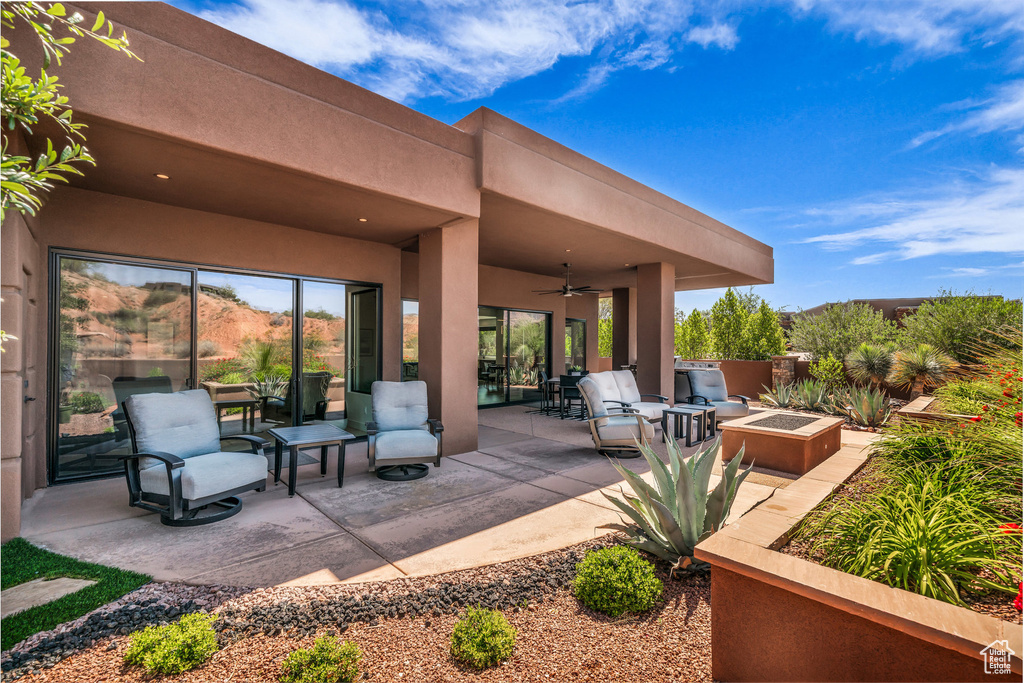 View of patio featuring a ceiling fan, an outdoor fire pit, and outdoor dining space