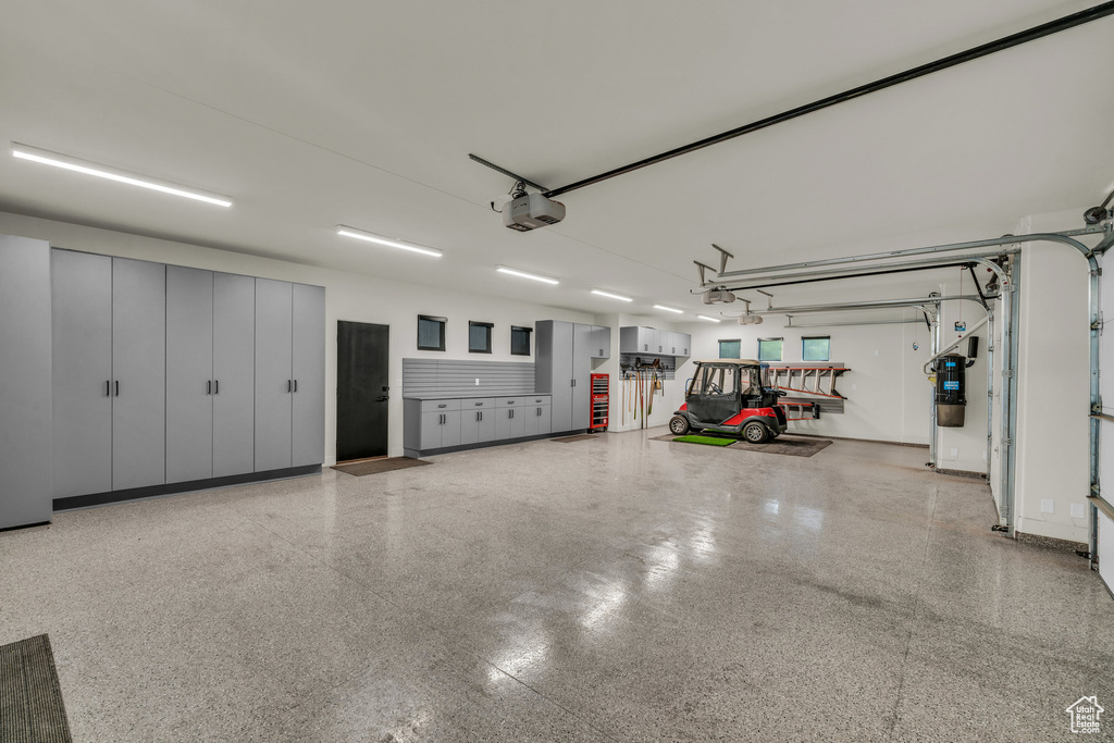 Garage featuring a central vacuum unit and a garage door opener