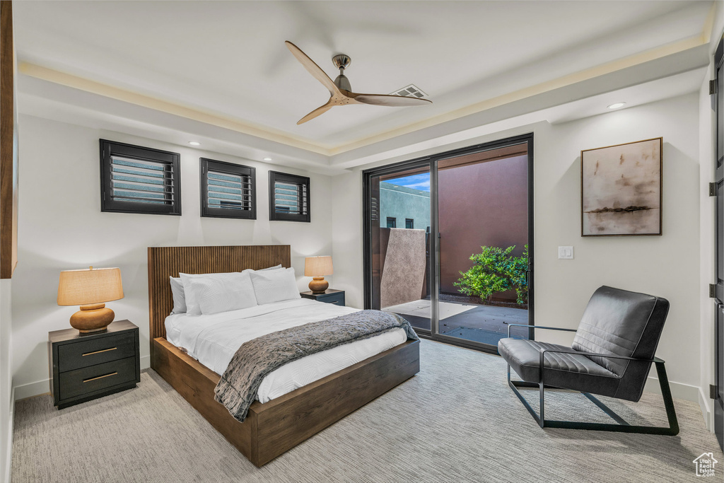 Carpeted bedroom with access to exterior, recessed lighting, a raised ceiling, baseboards, and ceiling fan
