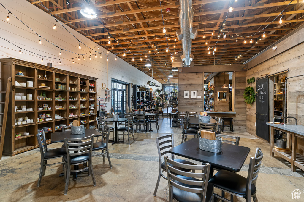 Dining area with wood walls and concrete flooring
