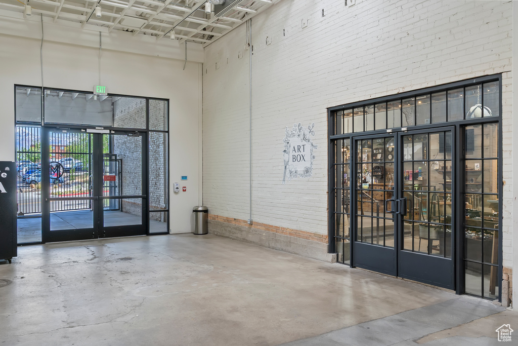 Community lobby with a high ceiling and brick wall
