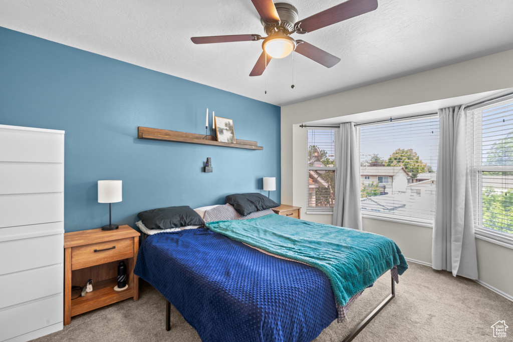 Bedroom with carpet flooring and a ceiling fan