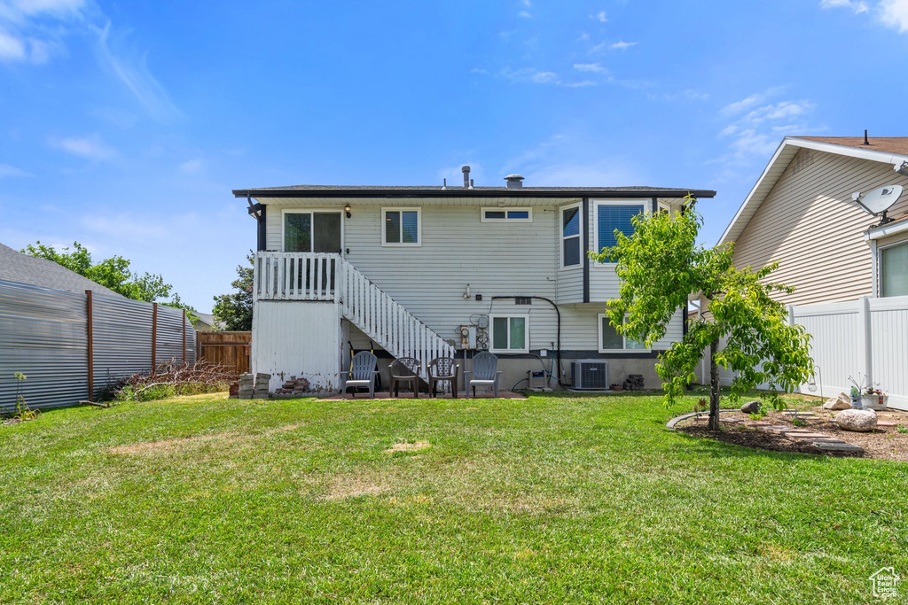 Rear view of property featuring central AC and stairs