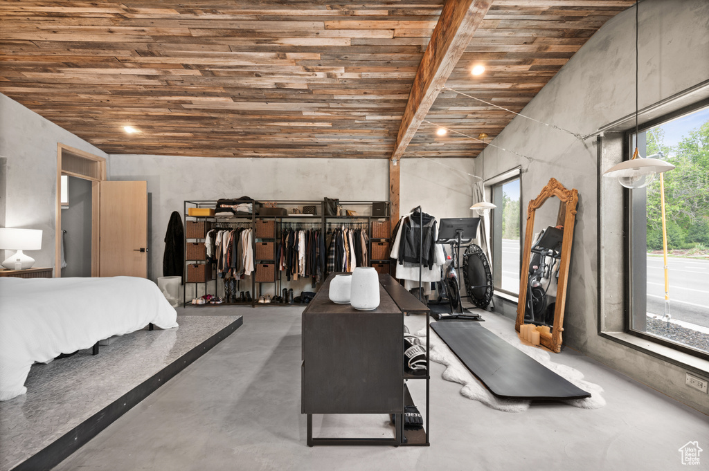Bedroom with concrete floors and wood ceiling