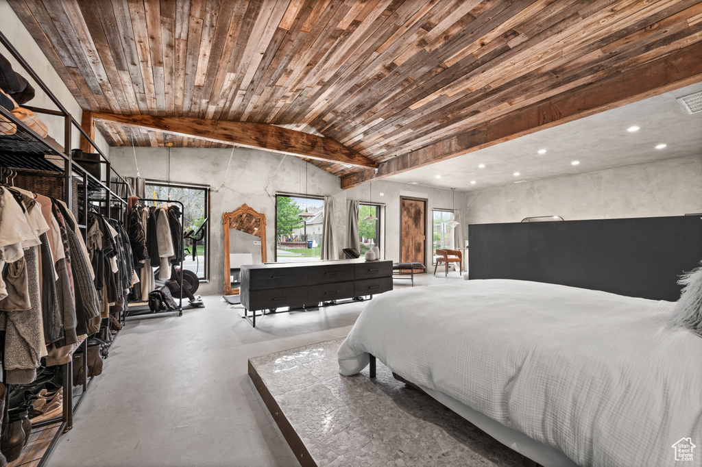 Bedroom featuring concrete flooring and lofted ceiling
