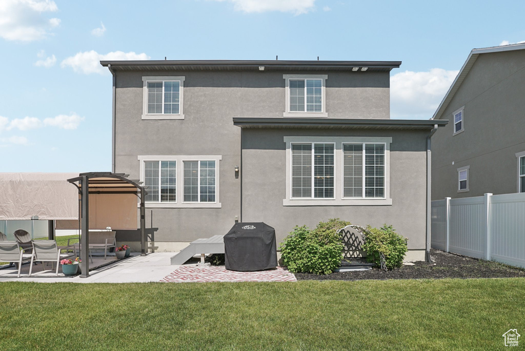 Back of property with stucco siding and a patio area