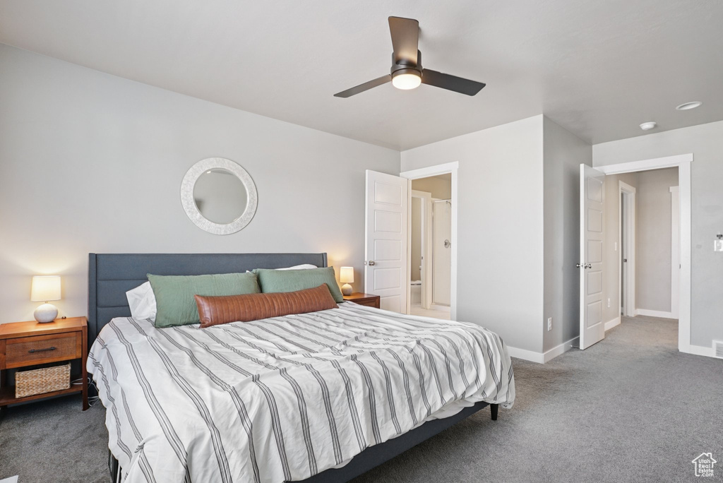 Carpeted bedroom featuring baseboards and a ceiling fan