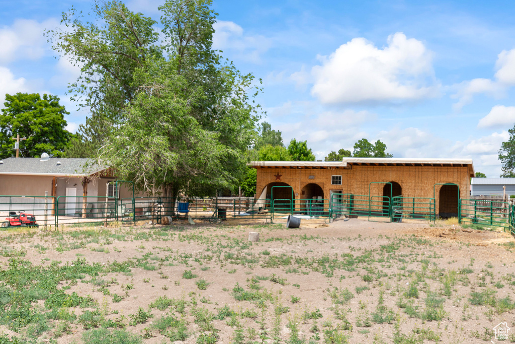 View of front of home featuring an exterior structure and an outdoor structure