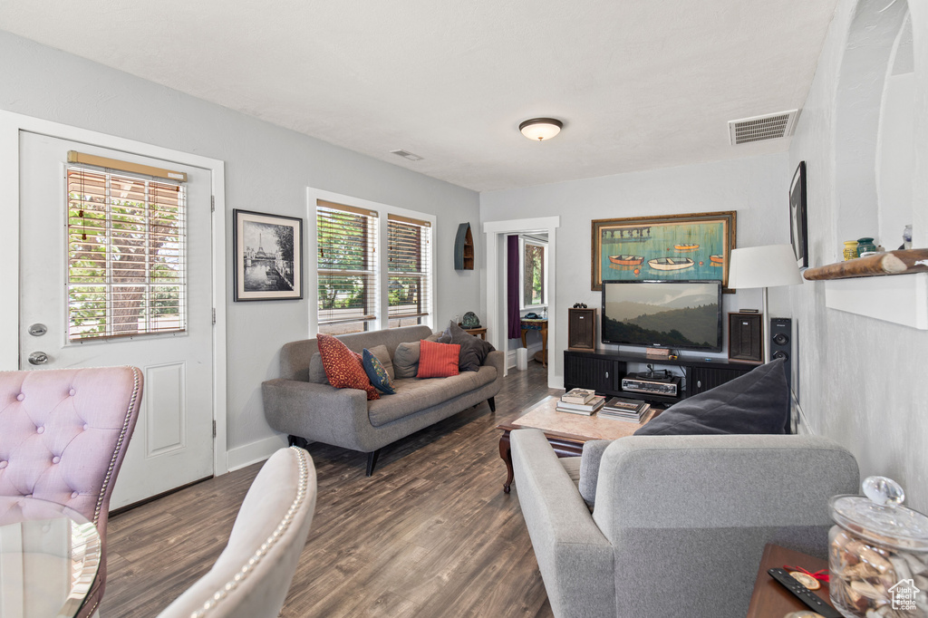 Living area with wood finished floors and baseboards