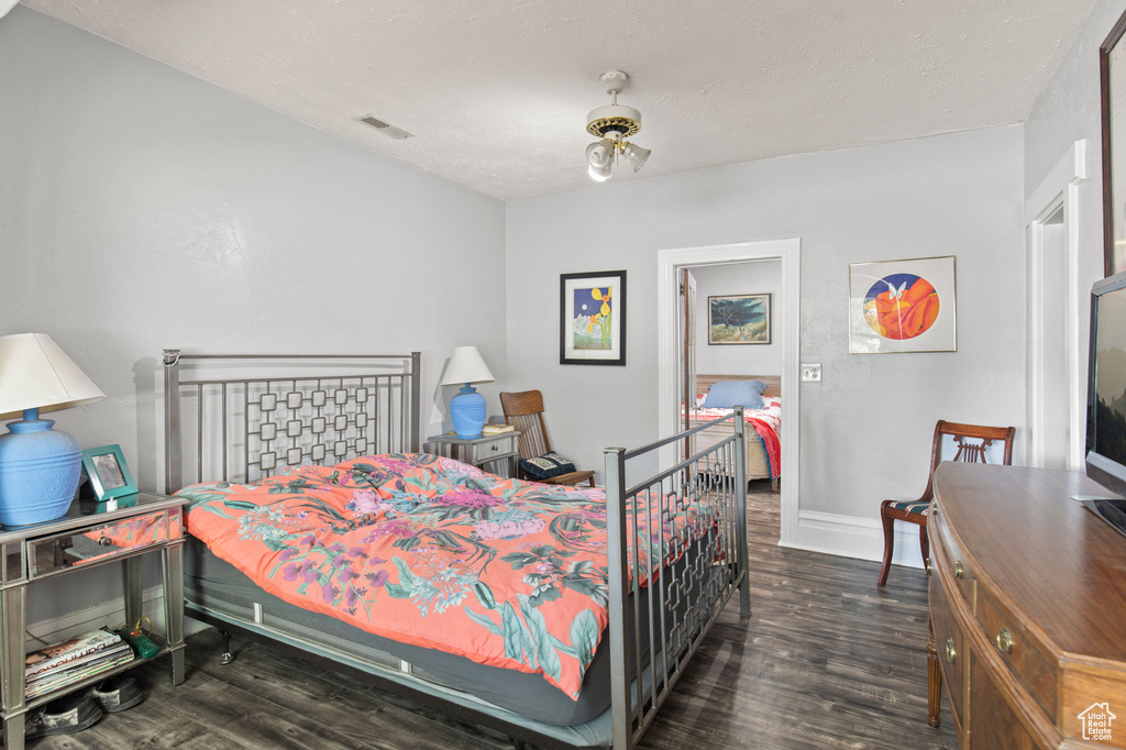 Bedroom featuring wood finished floors and baseboards
