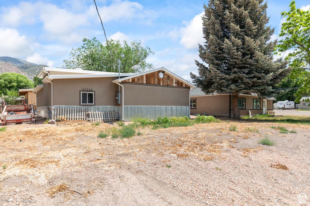 View of front of home featuring a mountain view and stucco siding