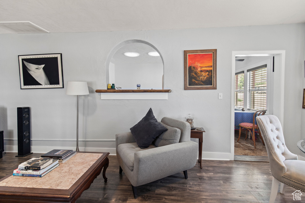 Living area featuring dark wood finished floors and baseboards