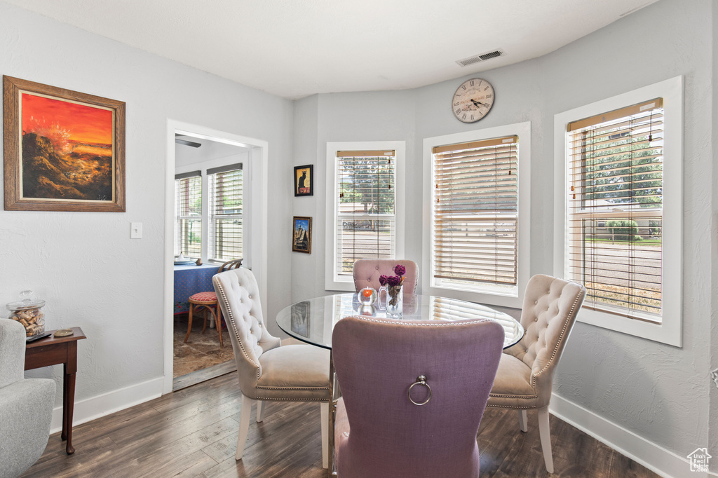 Dining area featuring baseboards and dark wood finished floors