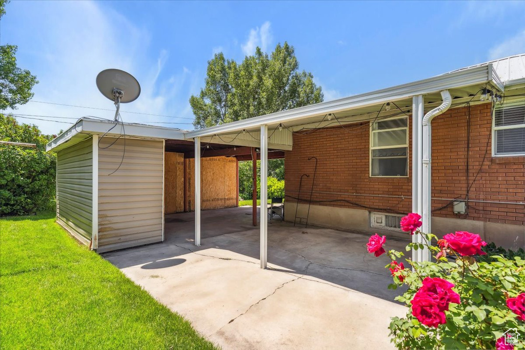 View of patio with an attached carport and driveway