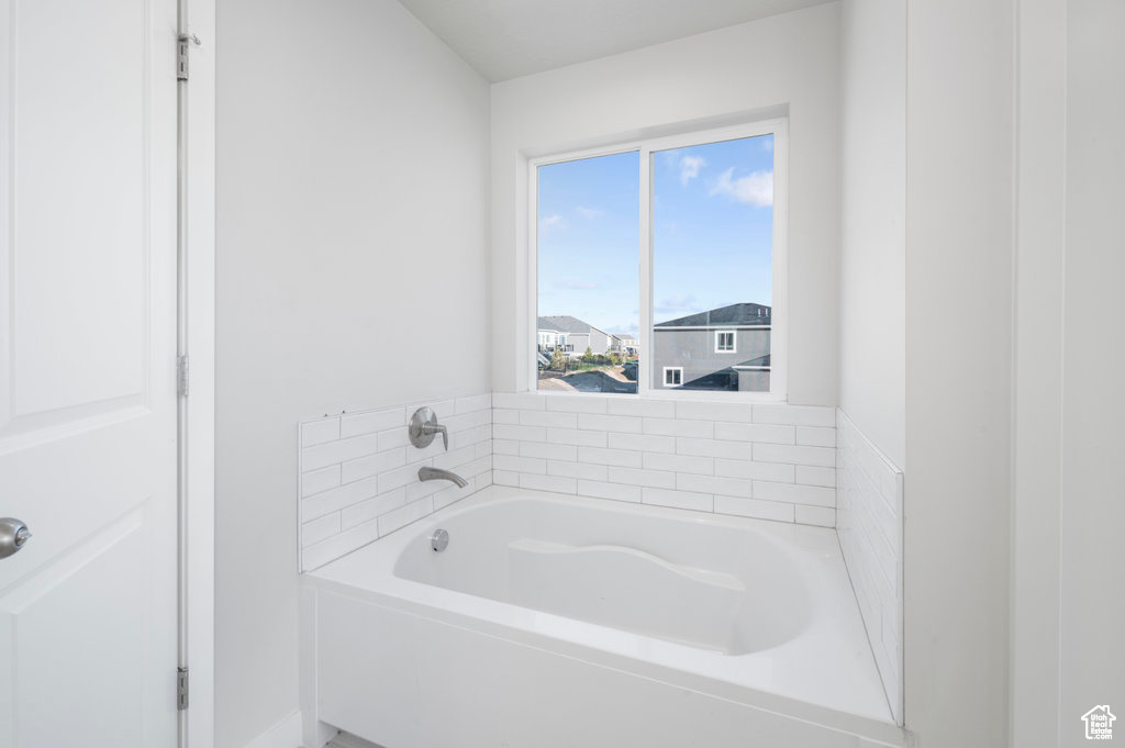 Full bathroom featuring a bath