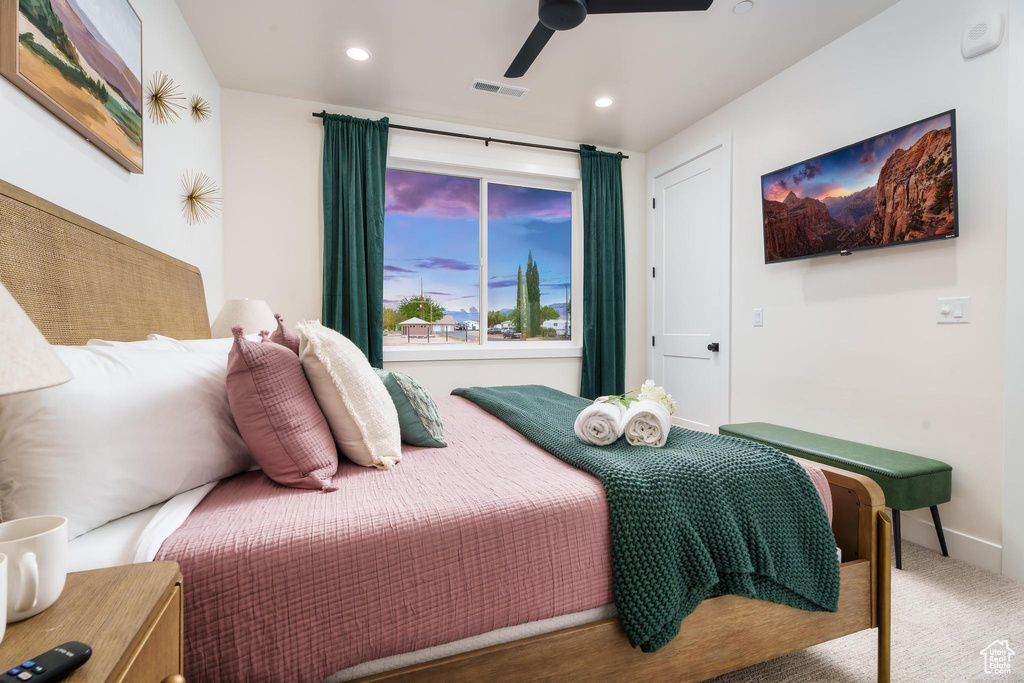 Carpeted bedroom featuring recessed lighting and a ceiling fan