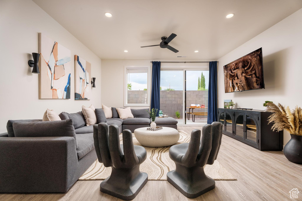 Living area with wood finished floors, a ceiling fan, and recessed lighting