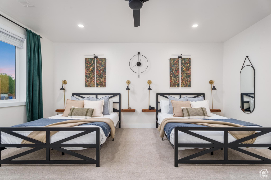 Carpeted bedroom with recessed lighting and a ceiling fan