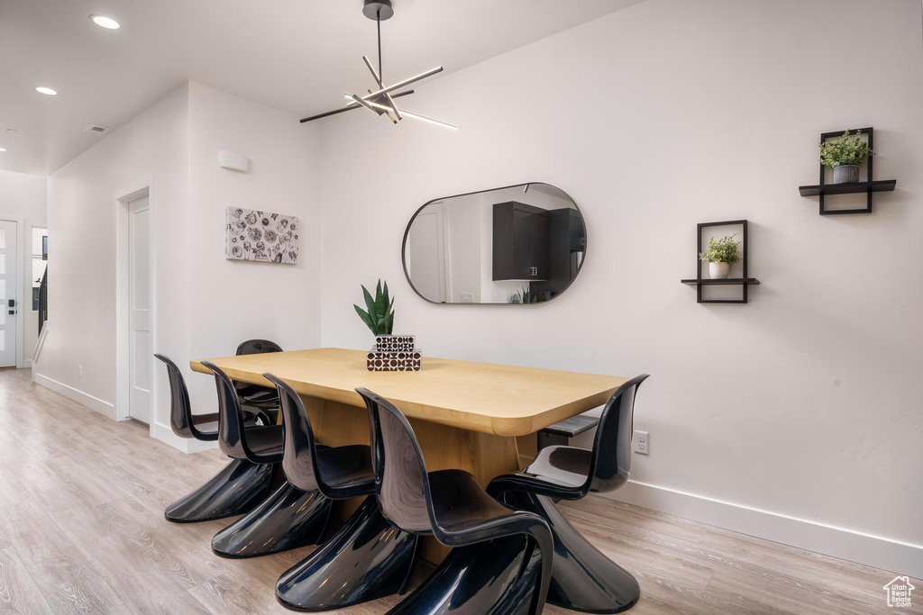 Dining room featuring baseboards, light wood-style floors, and recessed lighting