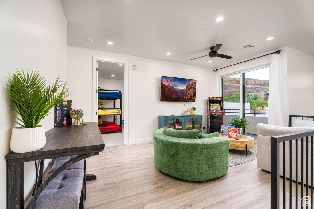Living room featuring ceiling fan, light wood finished floors, recessed lighting, and baseboards