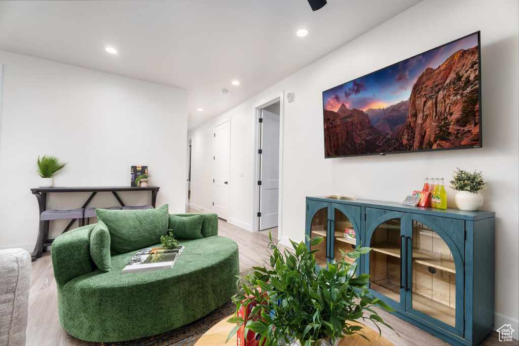Living room with wood finished floors, recessed lighting, and baseboards