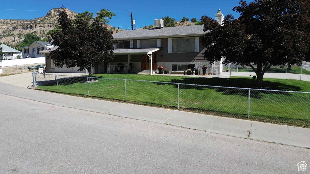 View of front of property with concrete driveway and a garage