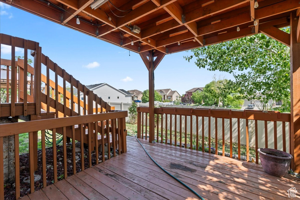 Wooden terrace featuring a residential view and stairs