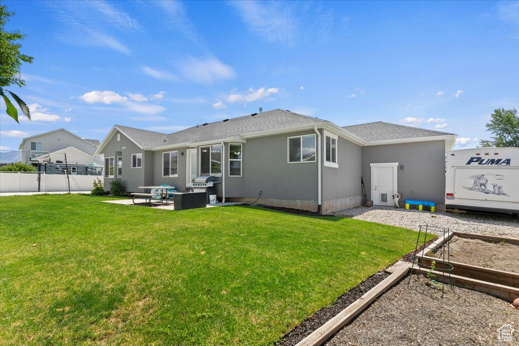 Back of property featuring outdoor lounge area, a patio area, and a vegetable garden