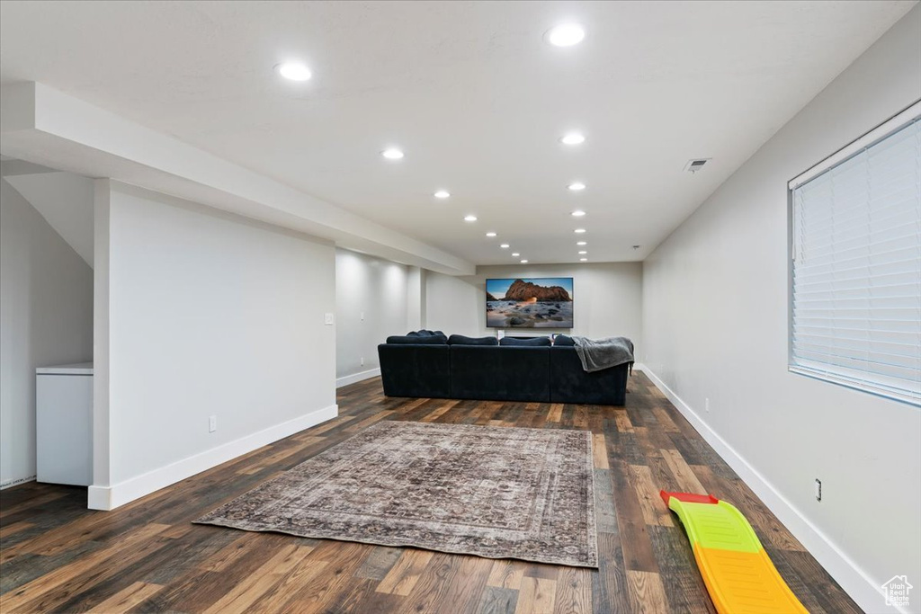 Living room with wood finished floors, recessed lighting, and baseboards