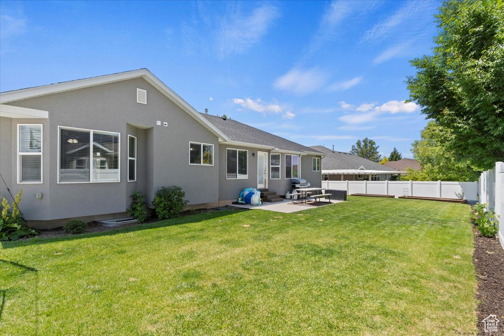 Back of property featuring a patio area, stucco siding, and entry steps