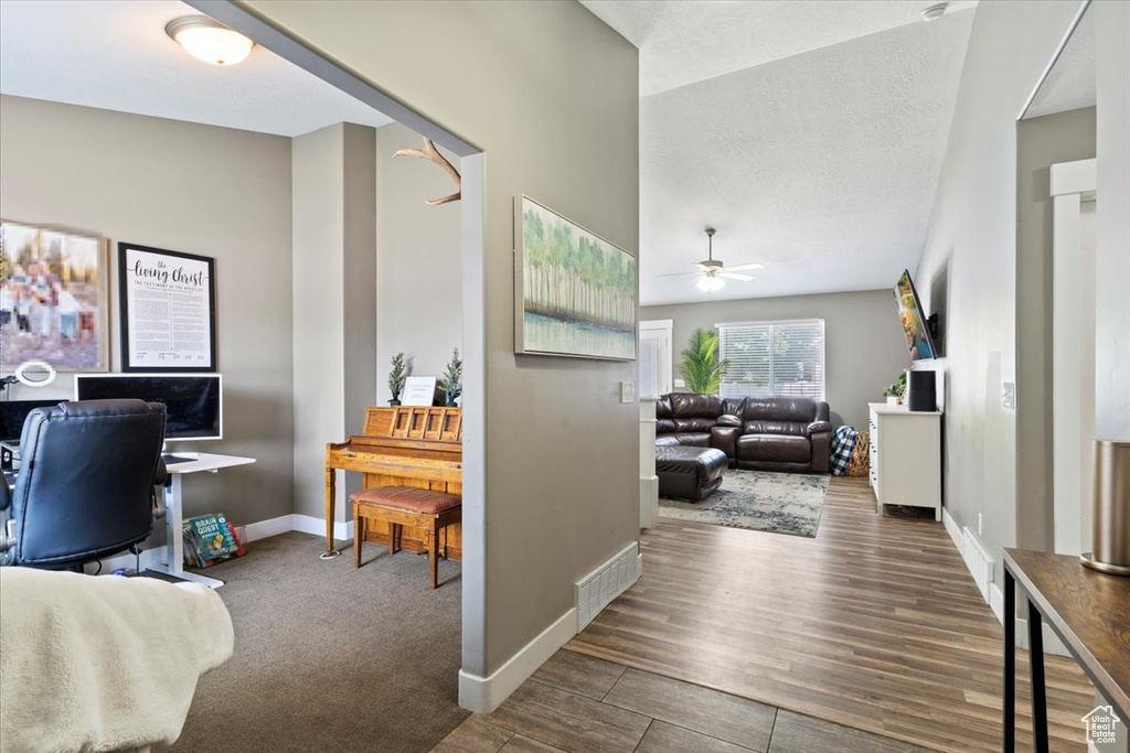 Office with a ceiling fan, baseboards, and wood finished floors