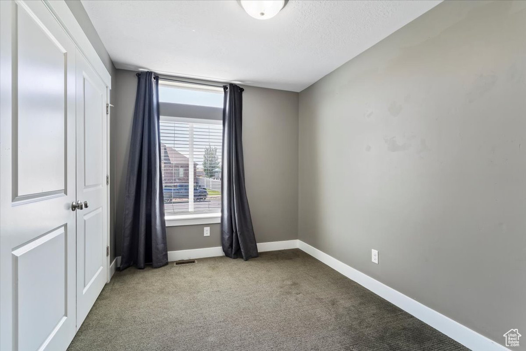 Unfurnished room featuring carpet flooring and baseboards