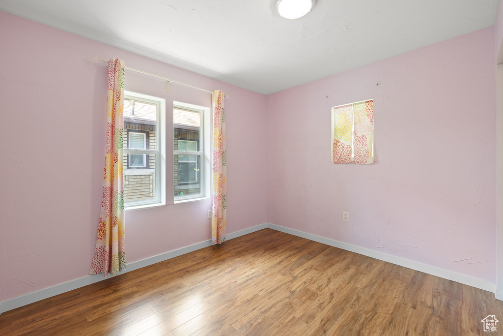 Spare room with wood finished floors and baseboards