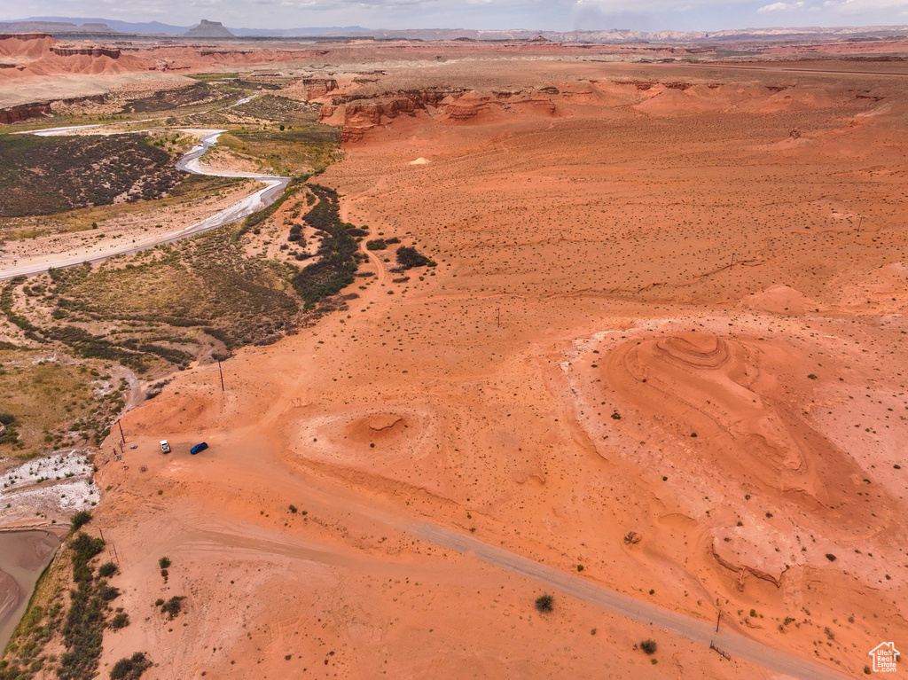 Aerial overview of property\\\'s location featuring a desert landscape, a mountainous background, and rural landscape