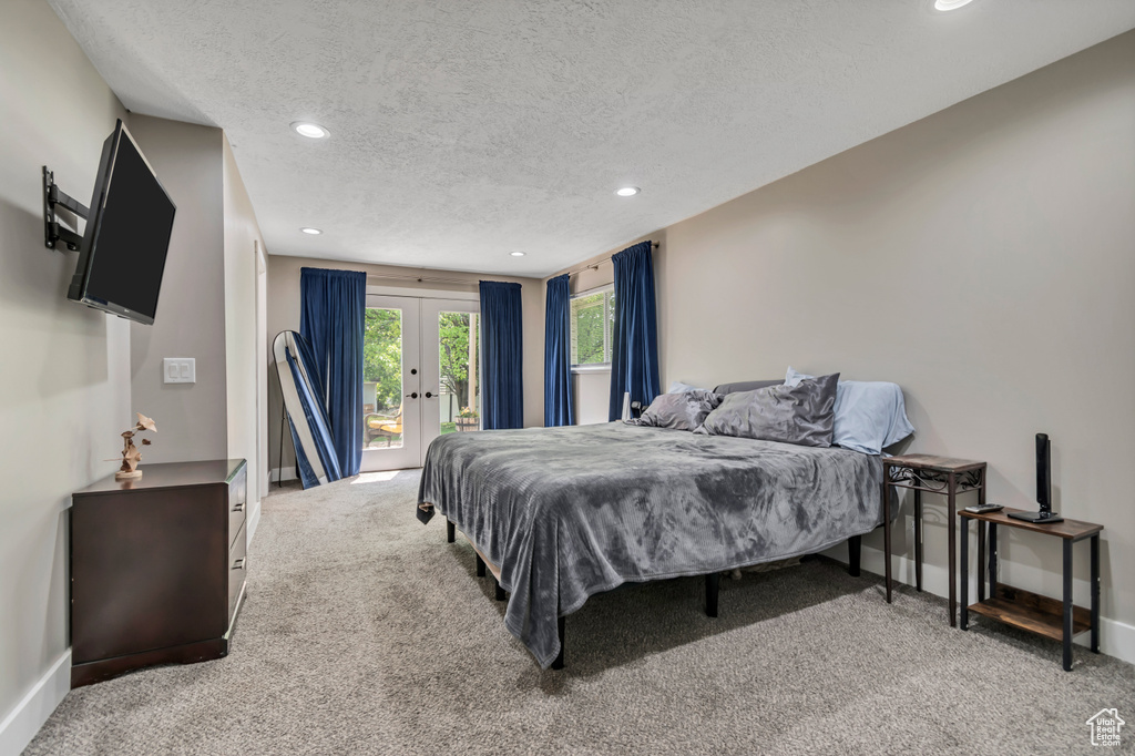 Bedroom with access to exterior, carpet, a textured ceiling, french doors, and recessed lighting