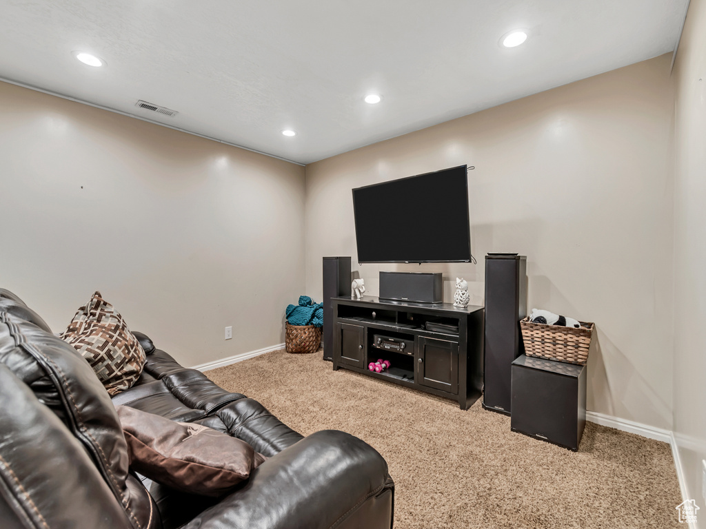 Living room featuring light carpet, baseboards, and recessed lighting