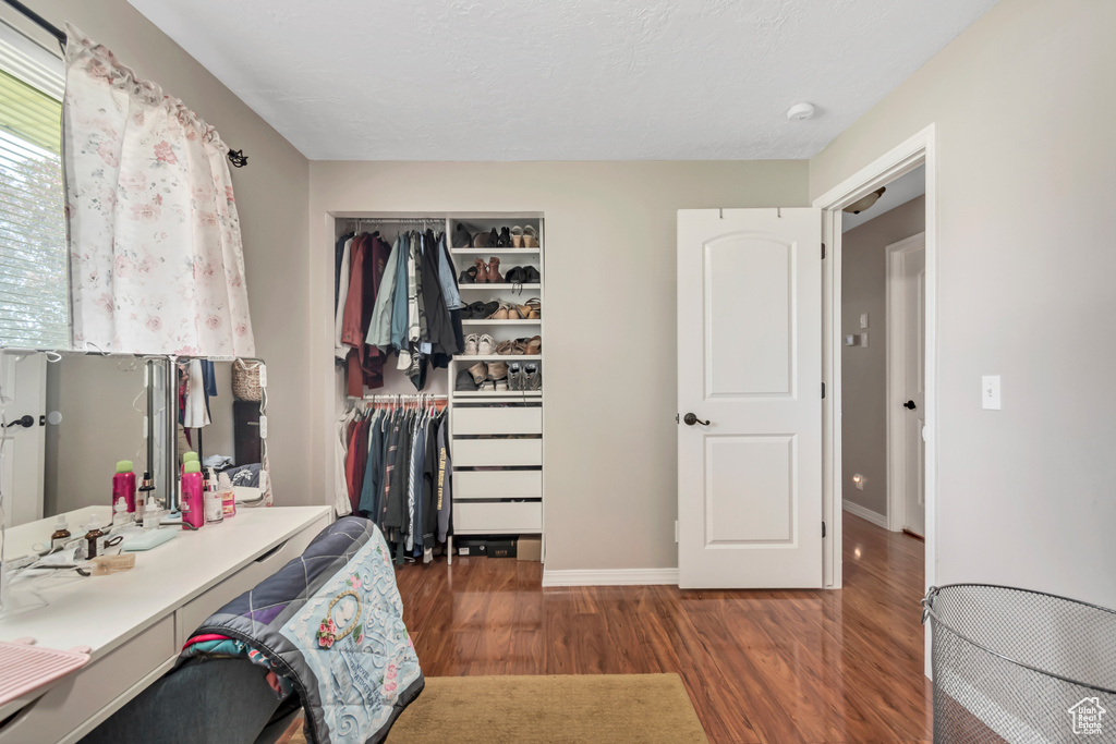 Bedroom featuring wood finished floors, a closet, and baseboards
