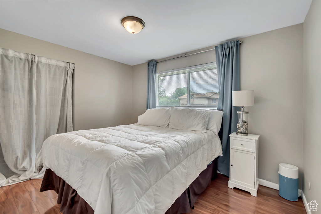 Bedroom with wood finished floors and baseboards