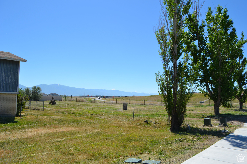 View of yard featuring a rural view and a mountain view