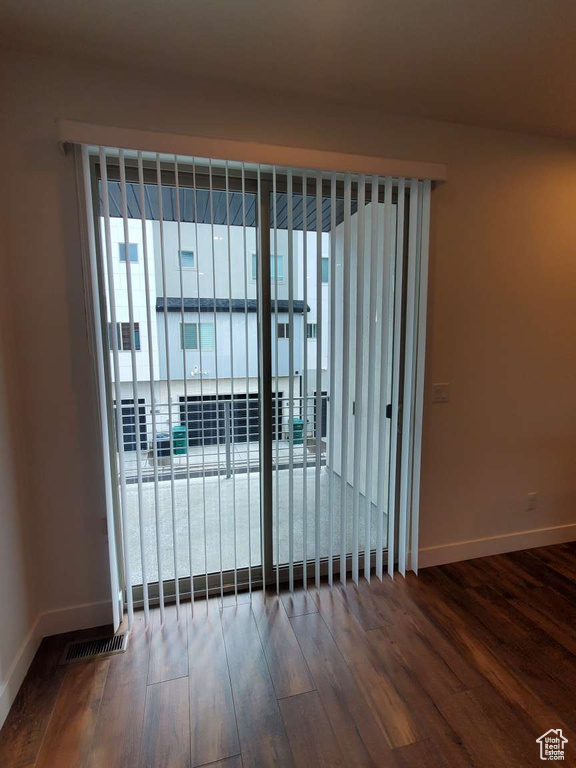 Empty room featuring wood finished floors and baseboards