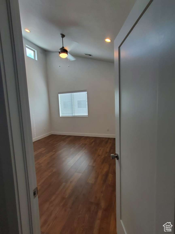 Unfurnished room featuring recessed lighting, ceiling fan, dark wood-type flooring, and baseboards