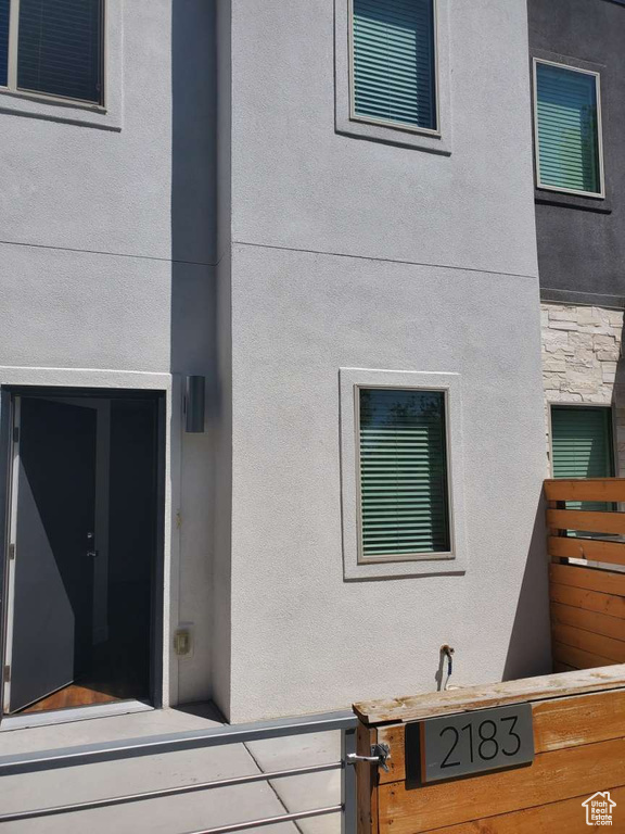 Property entrance with stucco siding and stone siding